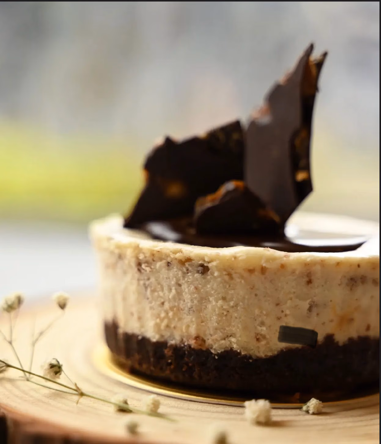 A cheesecake finished with a dark chocolate shard