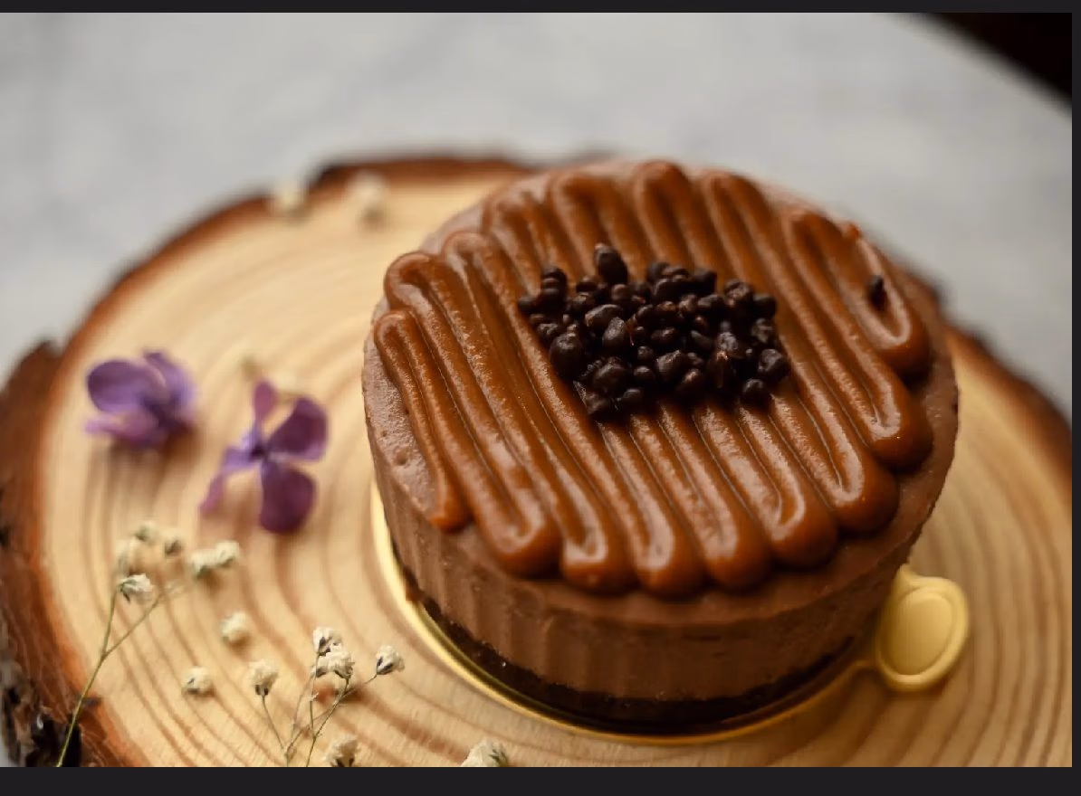 A coffee cheesecake decorated with chocolate coffee beans