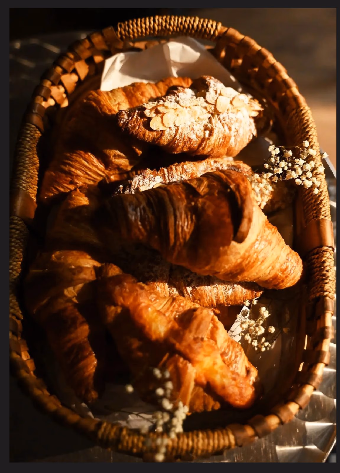 A basket of freshly baked croissants and pains au chocolat