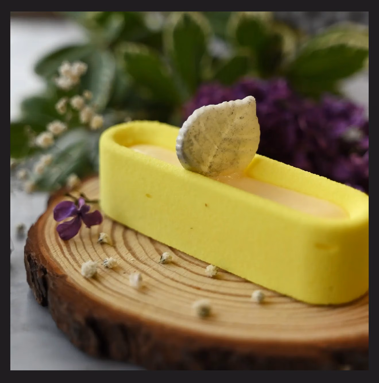 A lemon and pistachio slice on a wooden board
