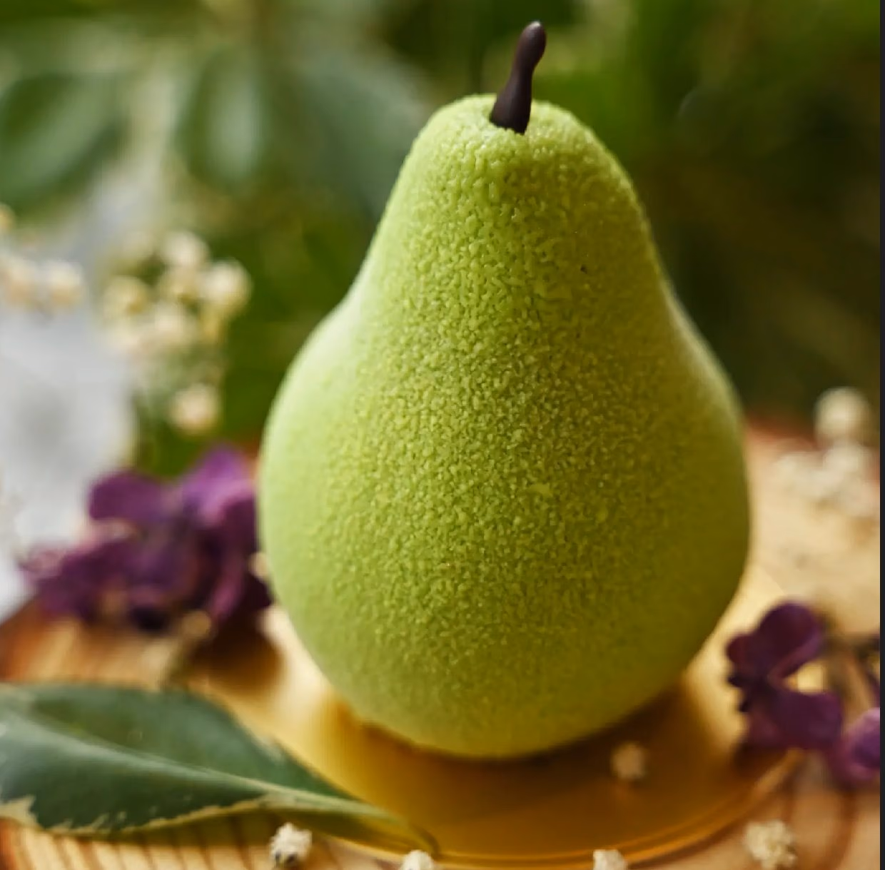A pear-shaped entremet with a velvet green finish