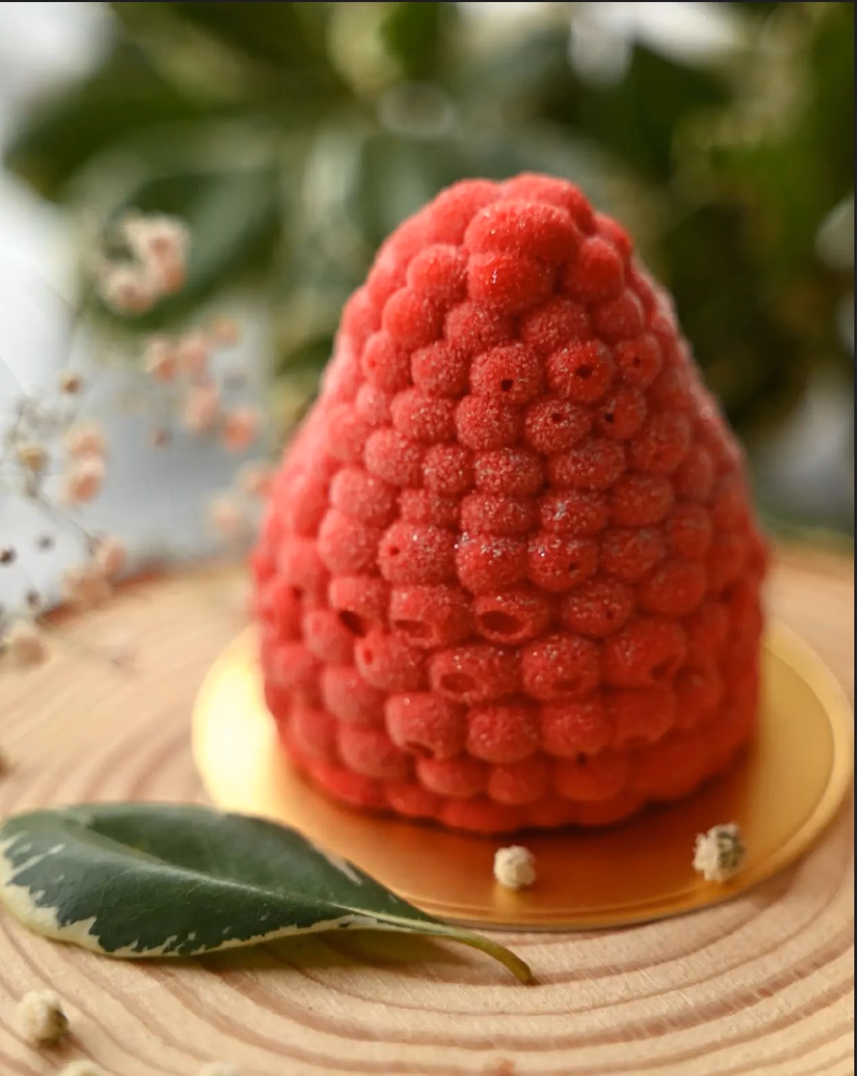 A raspberry entremet shaped and finished as a whole raspberry