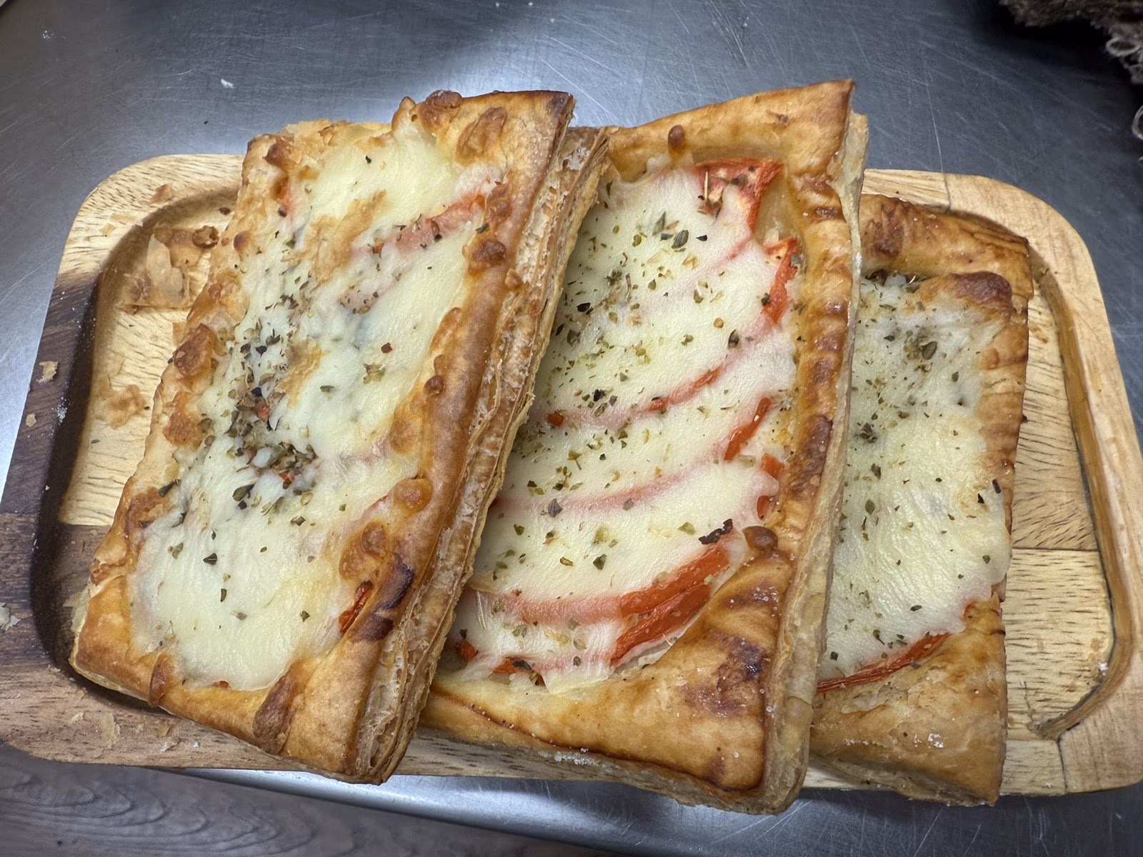 Tomato and cheese flatbread slices on a tray
